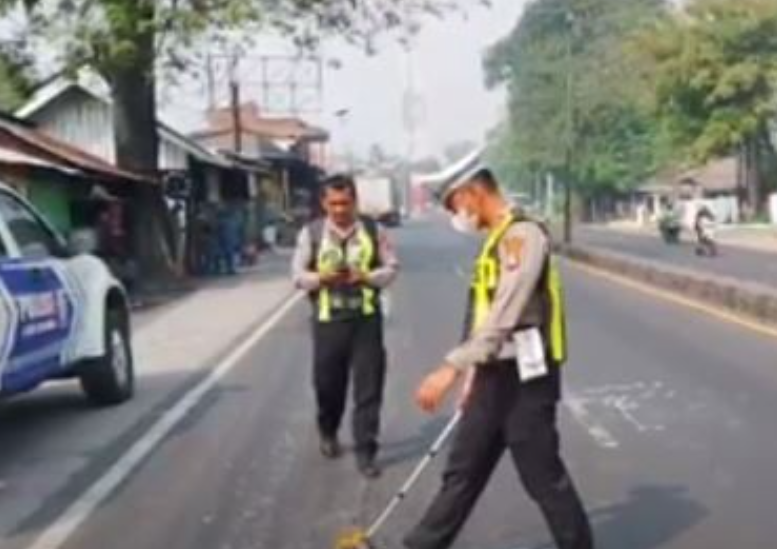 petugas unit laka satlantas polres pasuruan mengolah tkp kecelakaan maut motor yang ditumpangi tiga orang sekeluarga tertabrak truk