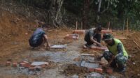 Anggota Satgas TMMD 122 Kodim 0420/Sarko Buka Cor Tiang Pondasi Kandang Kambing. Sabtu (12/10/2024).